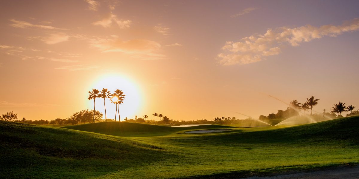 Golf course at sunset on Grand Cayman, Cayman Islands Golf course turf recovering after summer with Performance Soil Treatment by Performance Nutrition.